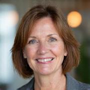 Portrait of Dr. Evelyn Reed, a friendly, professional woman.